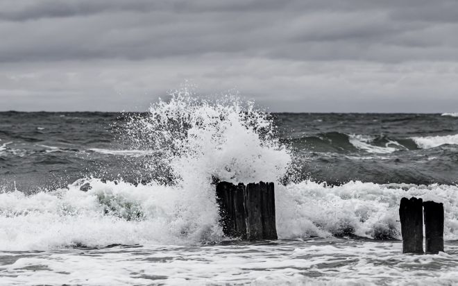 Ocean waves crashing on pilings