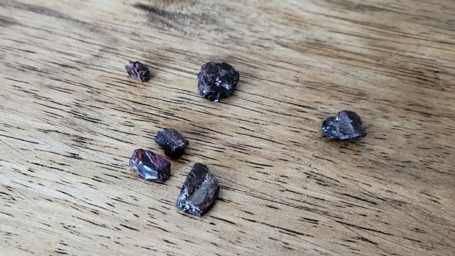 Rough Garnets on Wooden Tabletop