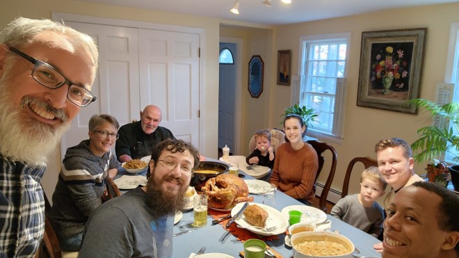 Family gathered around a table filled with food