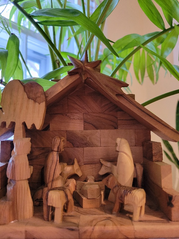 Wooden Manger Scene under palm plant