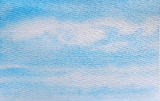 White clouds in a watercolor painted blue sky