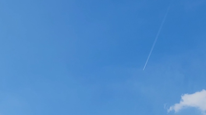 Fighter Jet and Contrail against a deep blue sky